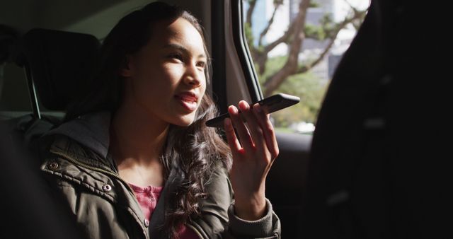 Asian woman talking on smartphone while sitting in the car. modern lifestyle and living concept