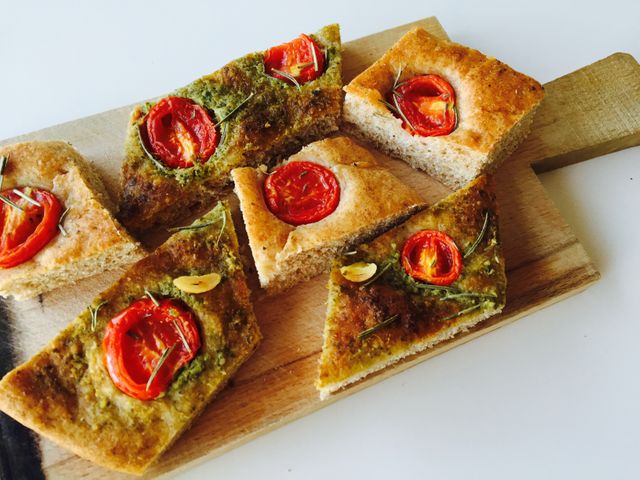 Rustic Homemade Focaccia with Tomato and Herb Topping on Wooden Board - Download Free Stock Photos Pikwizard.com