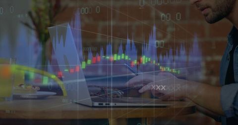 Man Using Smartphone and Laptop in Coffee Shop While Trading with Financial Charts Overlay