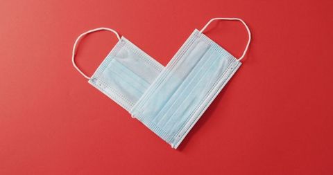 Heart-Shaped Face Masks on Red Background for Valentine's Day