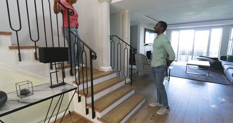 Friends Talking on Staircase in Modern Living Space