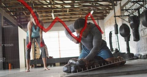 High-intensity boxing training showing real-time performance analytics overlay in warehouse gym