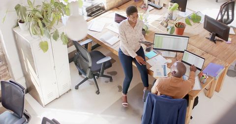 Engaging Business Meeting in Modern Tech-Savvy Office Environment