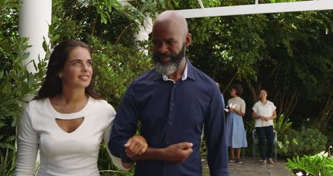 Guests socializing at an elegant garden wedding outdoors