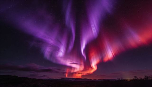 Dancing Violet and Crimson Northern Lights Ribbons Over Dark Hills and Starfield Horizon
