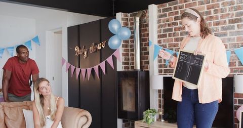 Friends Celebrating Baby Shower Playing Games Indoors
