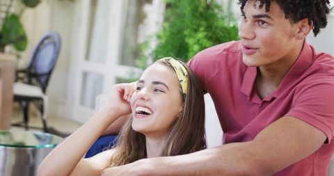 Joyful biracial couple embracing and connecting at home