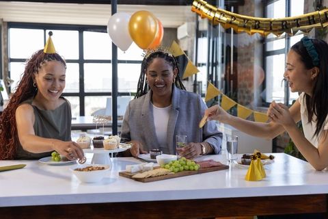 Diverse Female Coworkers Celebrating Birthday at Workplace
