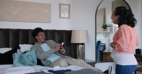 Happy couple packing for journey on special occasion