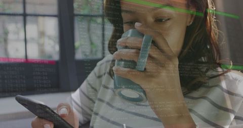 Woman Multitasking with Smartphone and Coffee Amidst Digital Interface