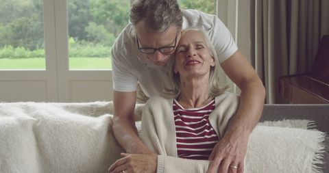 Senior Couple Embracing Peacefully in Cozy Home Setting