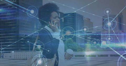 African american businesswoman on call with technological network overlay