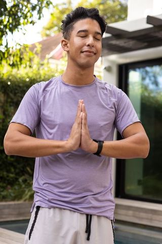 Peaceful Young Man Meditating Outdoors for Mindfulness and Serenity