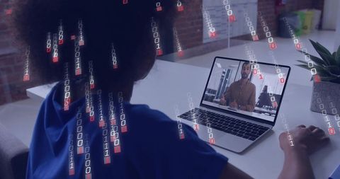 Woman watching virtual presentation on laptop with binary code overlay for cybersecurity
