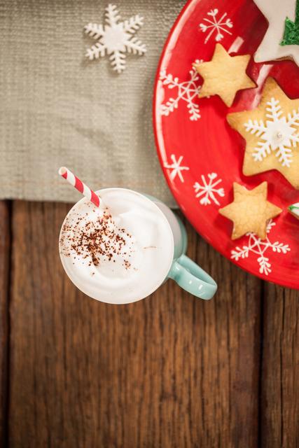 Sweet food and cappuccino on wooden table during christmas time