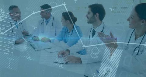 Medical team collaborating on patient metrics in hospital boardroom