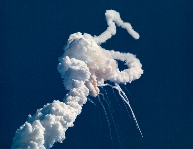 Exhaust plume and expanding gas cloud seconds after space shuttle Challenger explosion on January 28, 1986, resulting in loss of 51-L crew members. Captured during tragic space shuttle disaster over Kennedy Space Center. Significant for historical documentation and educational resources on space exploration incidents.
