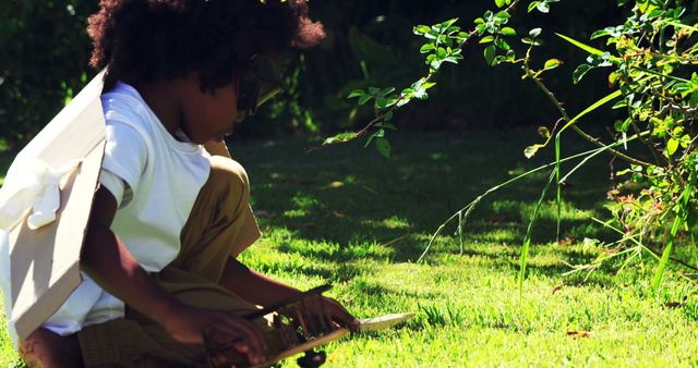 Child wearing aviator suit playing with toy airplane in backyard - Download Free Stock Images Pikwizard.com