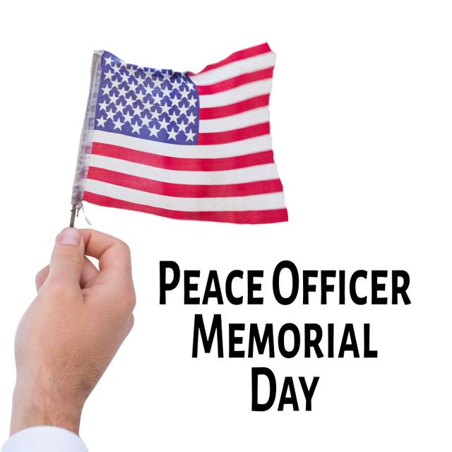 Honoring law enforcement, this image of a hand holding an American flag is suitable for Peace Officer Memorial Day commemorations. Use this to create memorial tributes, social media posts, banners, and programs dedicated to remembering fallen officers and celebrating their service. Also ideal for promoting patriotic themes and national unity.