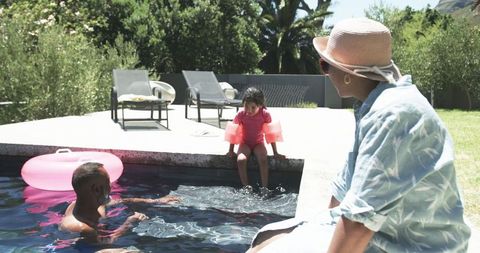 Family Bonding by Pool in Sunny Backyard - Download Free Stock Images Pikwizard.com