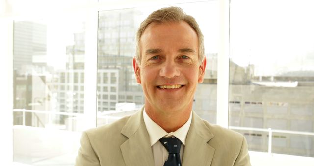 Confident Businessman in Suit Smiling in Modern Office Setting - Download Free Stock Images Pikwizard.com