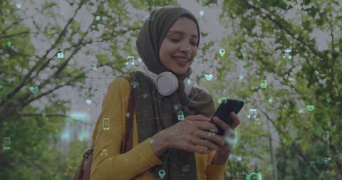 Smiling Woman in Hijab Using Smartphone with Digital Interface Overlay