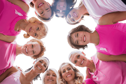 Circle of inspirational women in pink supporting breast cancer awareness
