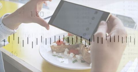 Framing tomato feta toast with smartphone for social media food photography and analytics