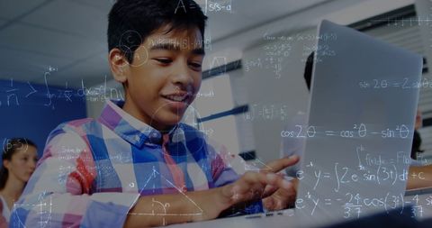 Schoolboy engaged with laptop surrounded by math equations