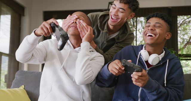 Teenage friends having fun while playing video games at home - Download Free Stock Images Pikwizard.com