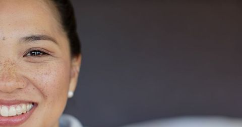 Smiling Half Face of Elegant Asian Woman with Smooth Complexion