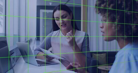 Professional Colleagues Discussing Documents with Laptop