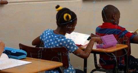 Digital learning: children engaged in school lessons with math overlays