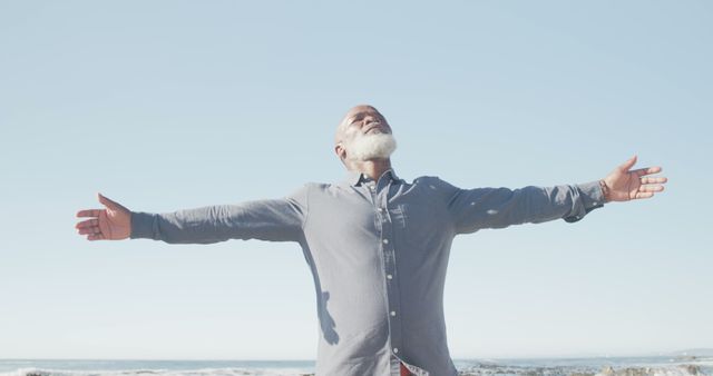 Senior man embracing freedom with open arms at beach - Download Free Stock Images Pikwizard.com