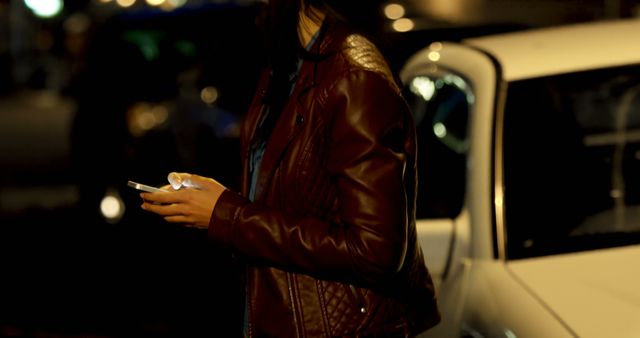 Young Woman Using Smartphone at Night Near Parked Car - Download Free Stock Images Pikwizard.com