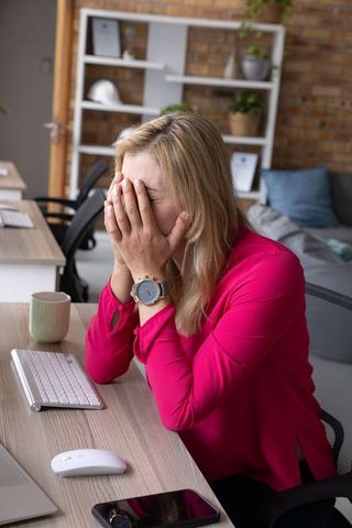 Stressed Woman at Work in Modern Office Environment