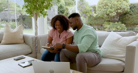 Couple Collaborating at Home with Technology and Notes