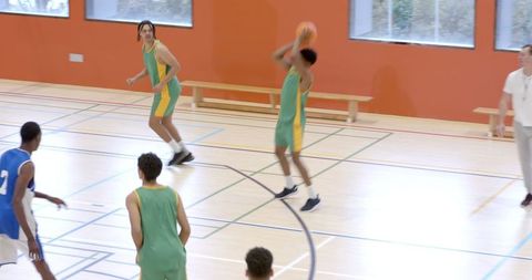 Energetic Indoor Basketball Match with Diverse Athletes and Coach