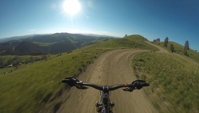 Mountain Biking Adventure on Rolling Hills Under Clear Sky