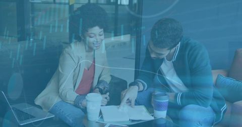 Diverse Business Team Reviewing Data with Digital Graph Overlay