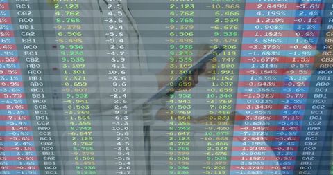Businesswoman Using Smartphone to Track Stock Tickers in Modern Office