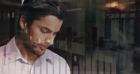 Indian Businessman Analyzing Data with Office Reflection