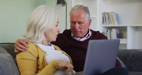 Senior Couple Discussing on Sofa Using Laptop at Home - Download Free Stock Images Pikwizard.com