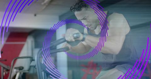 Focused Athlete on Air Bike in Modern Industrial Gym with Dynamic Overlay