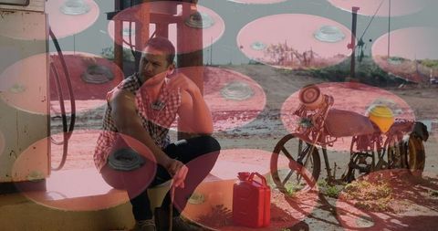 Digital Layers Show Man with Fuel Cans at Rural Petrol Station