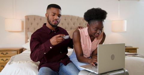 Young Couple Enjoying Online Shopping Experience at Home