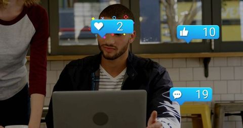 Man working on laptop in cafe with social media reaction overlays for marketing