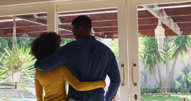 Happy african american couple embracing together at home - Download Free Stock Photos Pikwizard.com