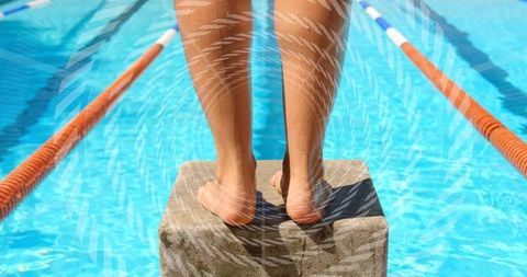 Standing on starting block preparing to dive into competition pool