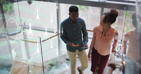 Colleagues Discussing Data Processing with Digital Interface